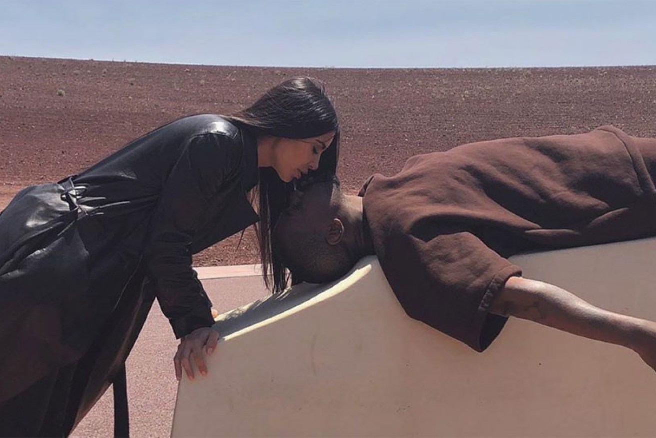 Kim Kardashian West and Kanye West celebrated New Year's Eve with a posed kiss and a Wyoming ski trip.