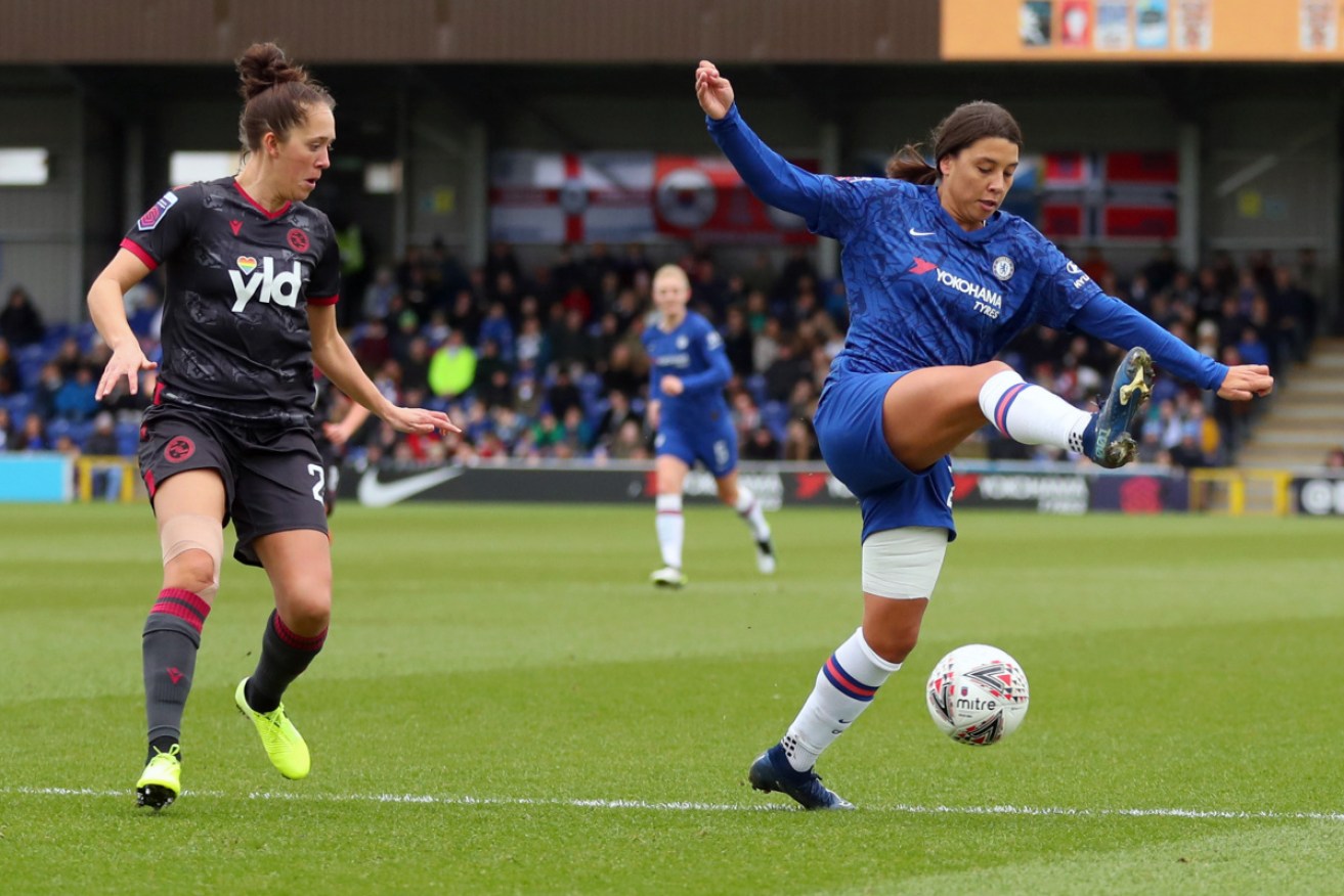 Cold debut: Sam Kerr traps a ball ahead of Reading's Jo Potter. 