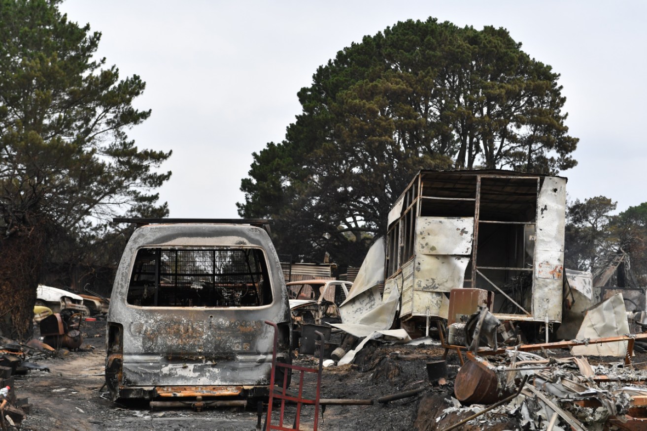 The burnt out remains of vehicles are seen from a bushfire in the Southern Highlands town of Wingello, 160km south west of Sydney.