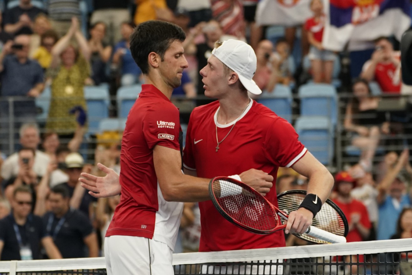 Serbia's Novak Djokovic and Denis Shapovalou meet at the net after their boisterous match.