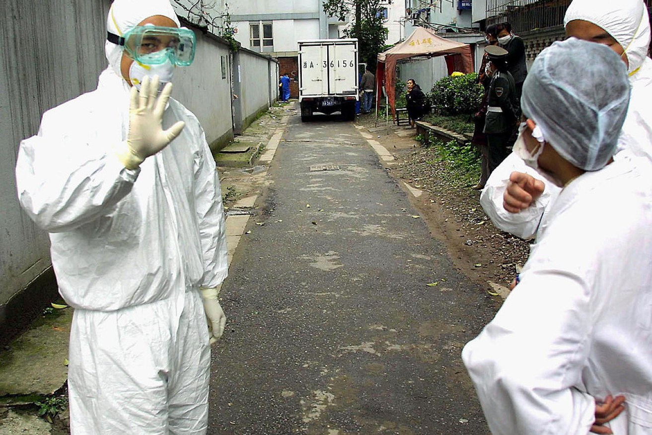 A mystery virus infecting Chinese had initially sparked fears that SARS had made a comeback (pictured: health authorities respond to SARS in 2003).
