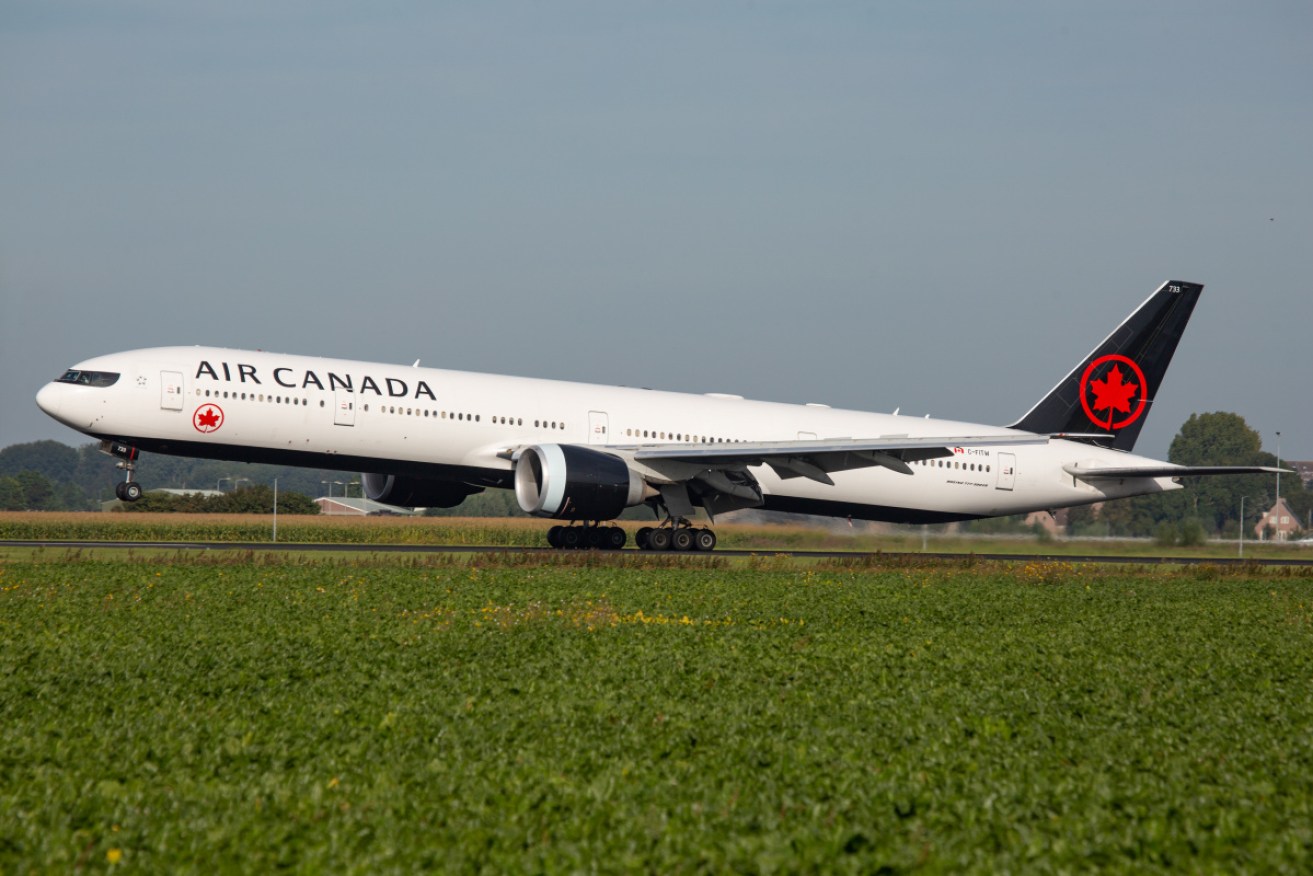 A man travelling with his wife and five children on an Air Canada flight to Australia has died during the journey, with the plane diverted to Honolulu.