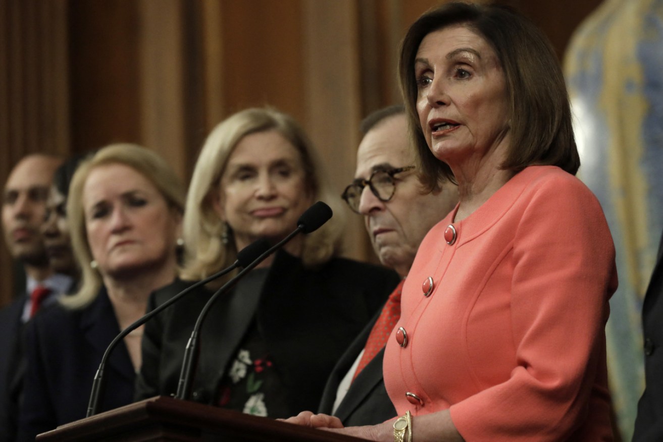 US House Speaker Nancy Pelosi (D-CA) signs the articles of the impeachment against Mr Trump during an Engrossment Ceremony on Capitol Hill.