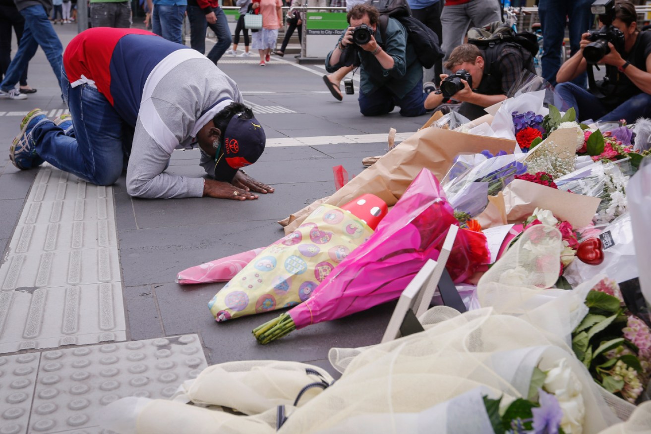 People paid their respects to the victims by laying flowers at Bourke Street Mall.