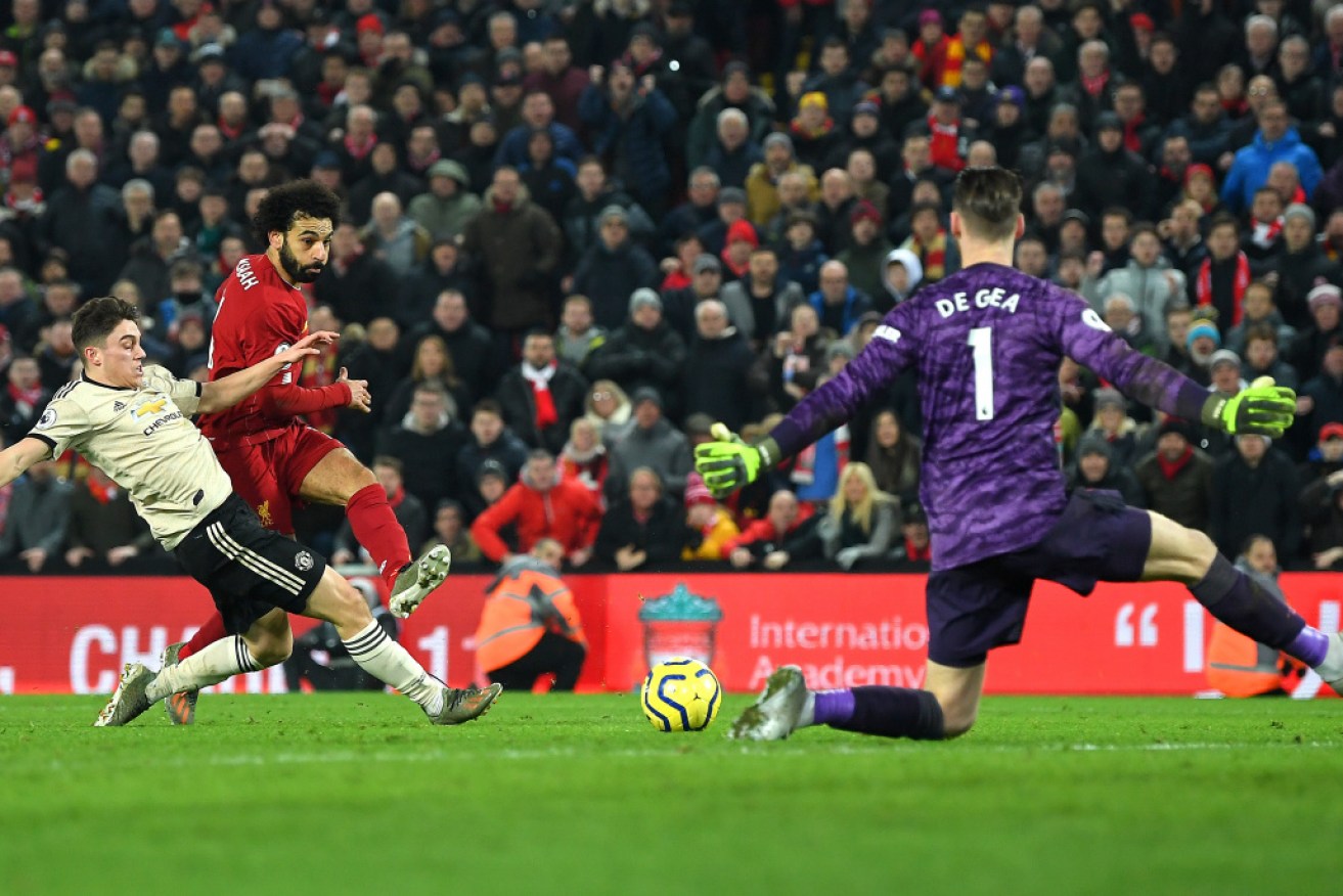 Mohamed Salah scores Liverpool's second to clinch the points against Manchester United.