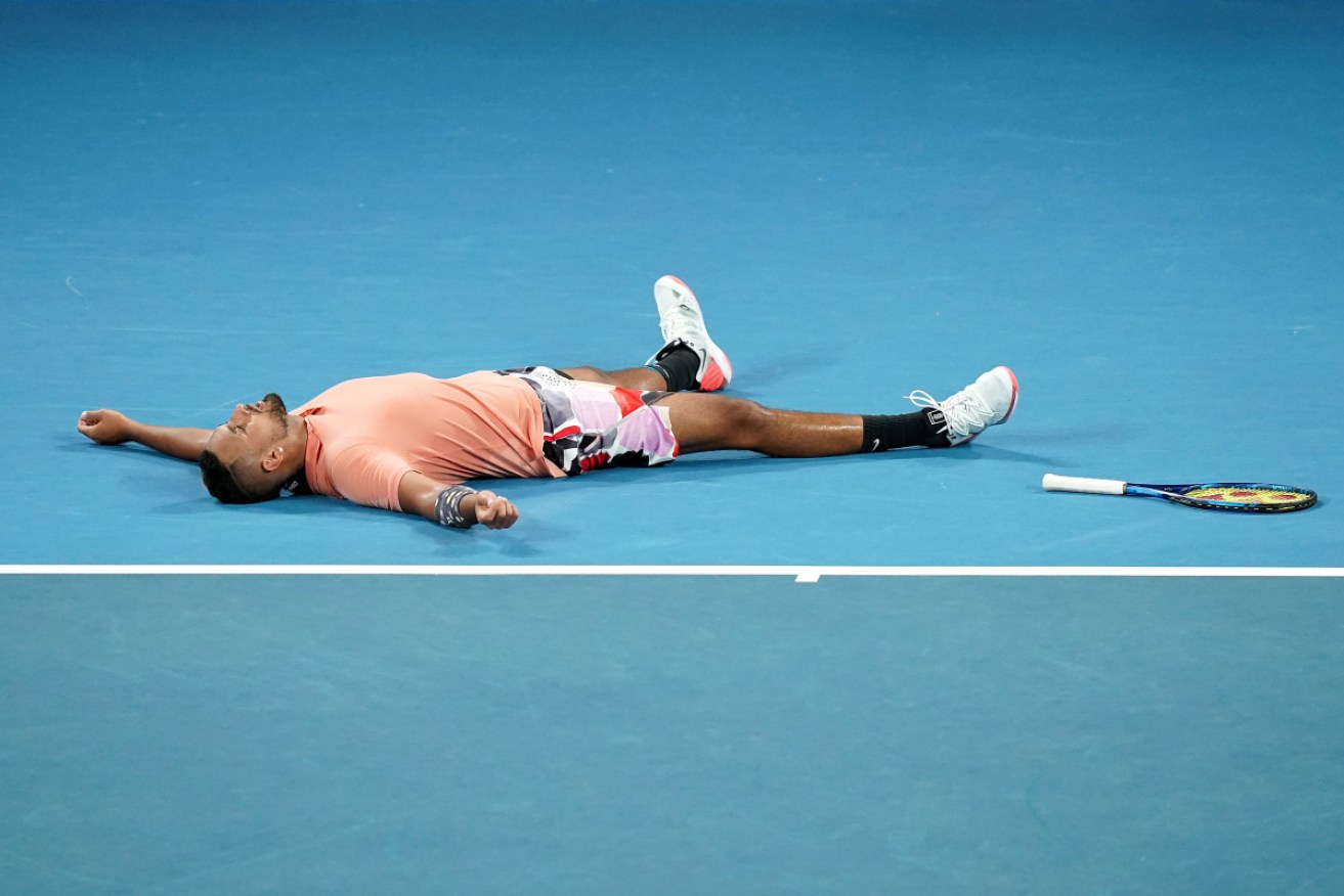 Wrecked: Nick Kyrgios collapses after his draining five set match. 