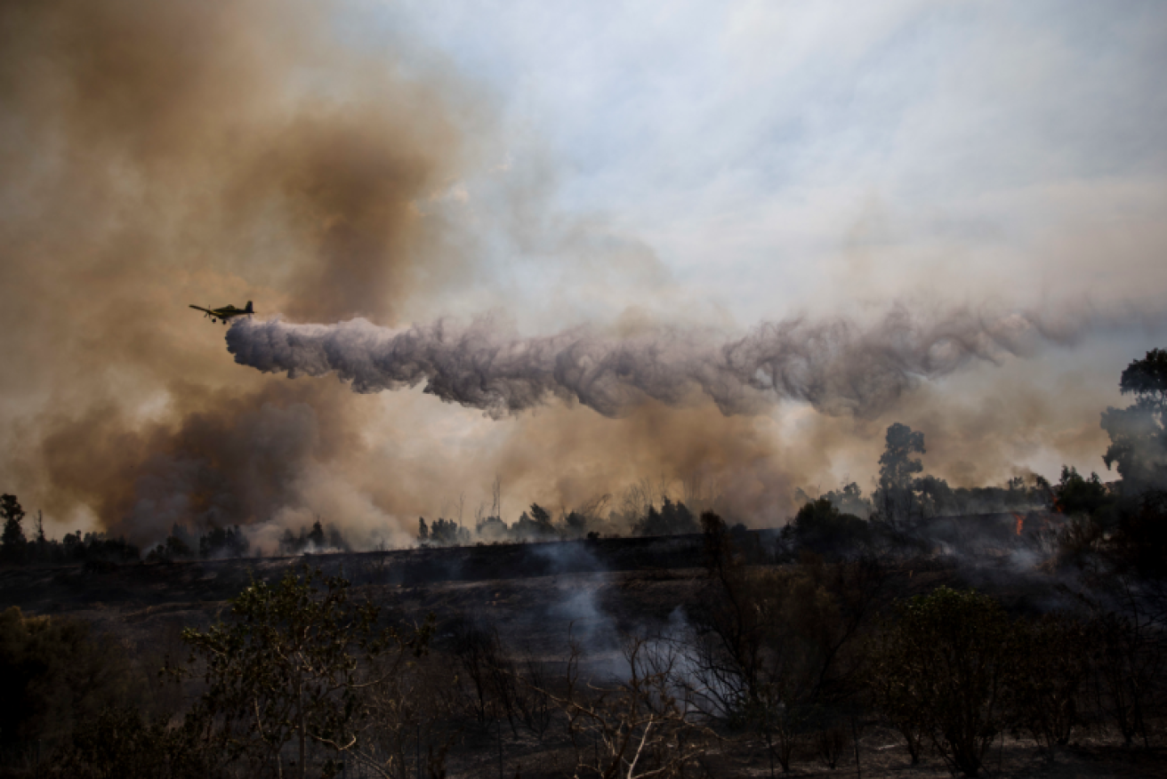 A water bomber blitzes one of the fires sparked by the Hamas balloons.