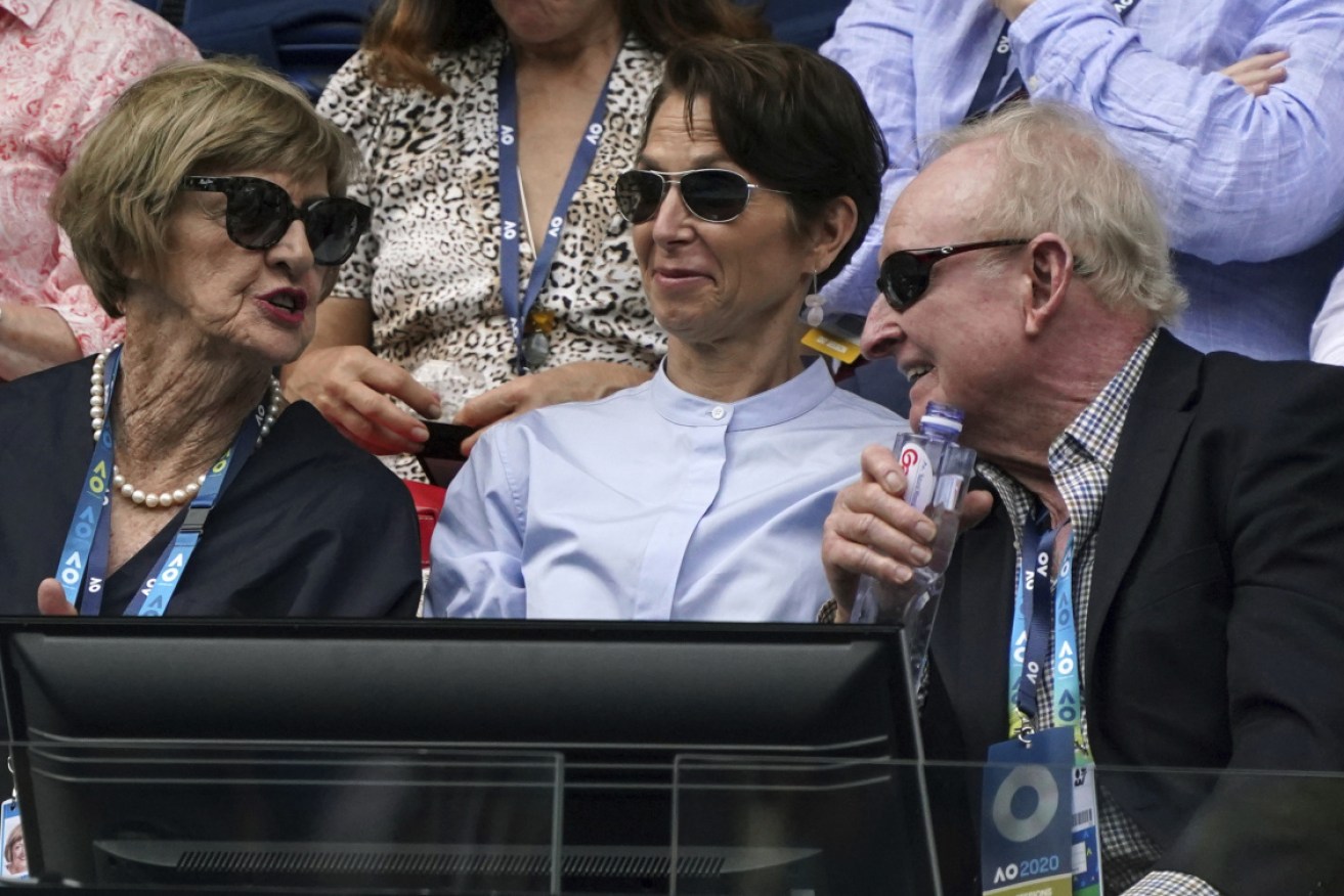 Rod Laver shares a joke with Margaret Court (left) at the Australian Open on Sunday.