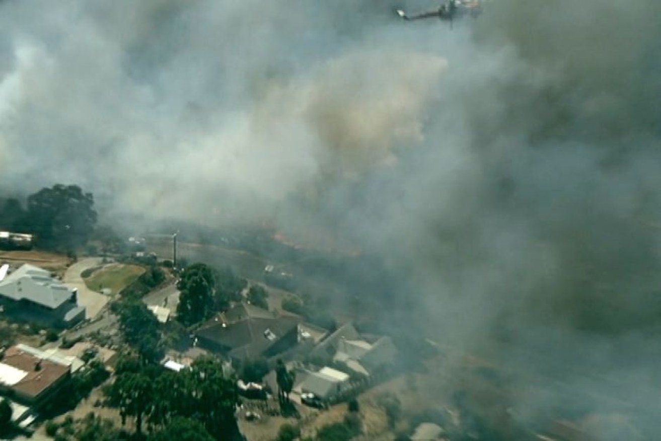 The fire is burning close to homes in the Perth Hills suburb of Forrestfield.