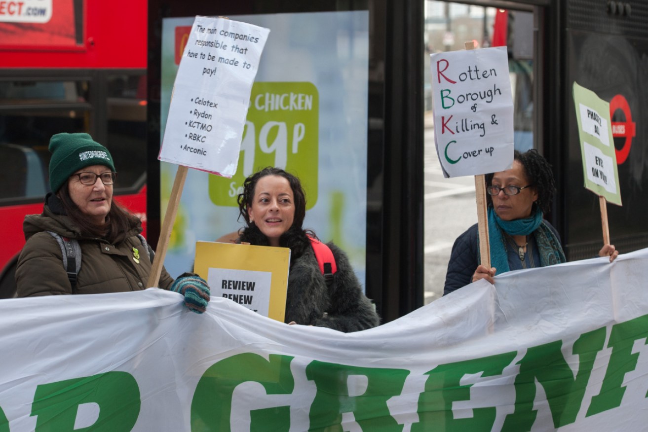 Survivors of the disaster and their allies protest outside the inquiry in London on Monday. 