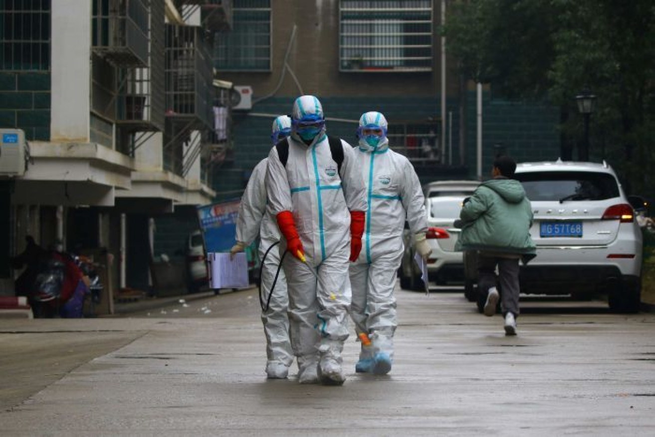 Workers from local disease control disinfect a residential area in Ruichang, Jiangxi province in China.