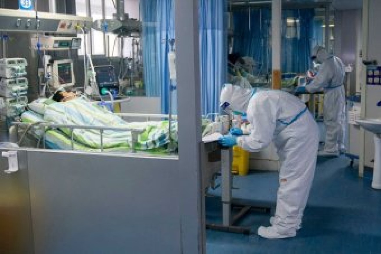 A medical worker attends to a patient in the intensive care unit at Zhongnan Hospital in Wuhan. Photo: Xinhua/Xiong Qi