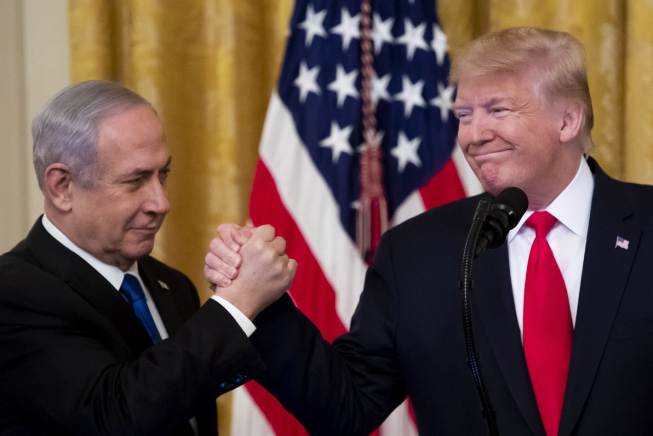 US President Donald J. Trump (R) shakes hands with Prime Minister of Israel Benjamin Netanyahu while unveiling his Middle East peace plan.