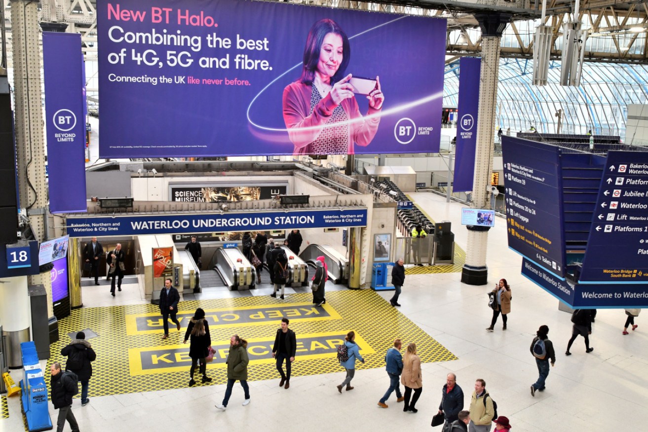 A billboard advertising 4G, 5G and fibre mobile telecommunication is displayed at Waterloo Underground Station in London.