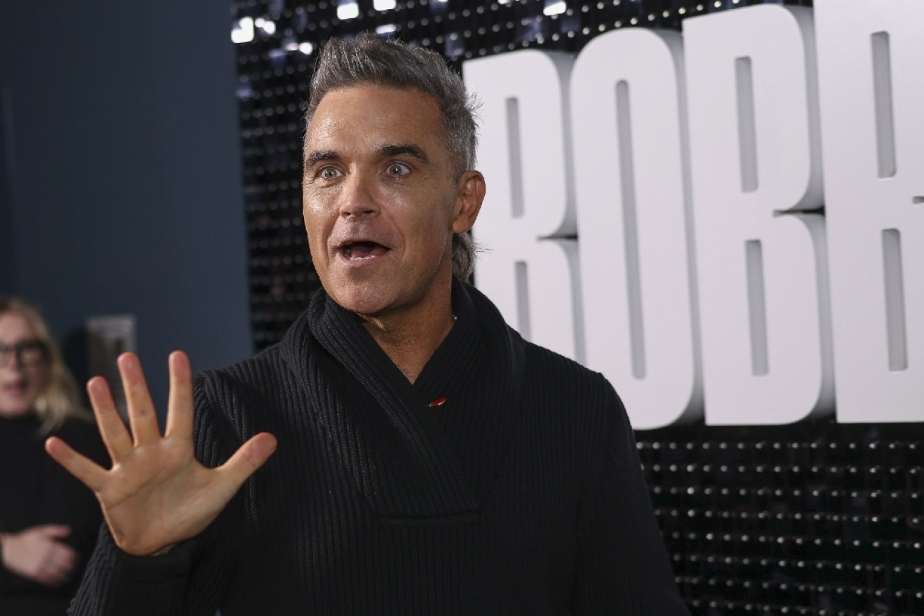 Robbie Williams has triumphed in a spat with neighbours over a sick tree.
