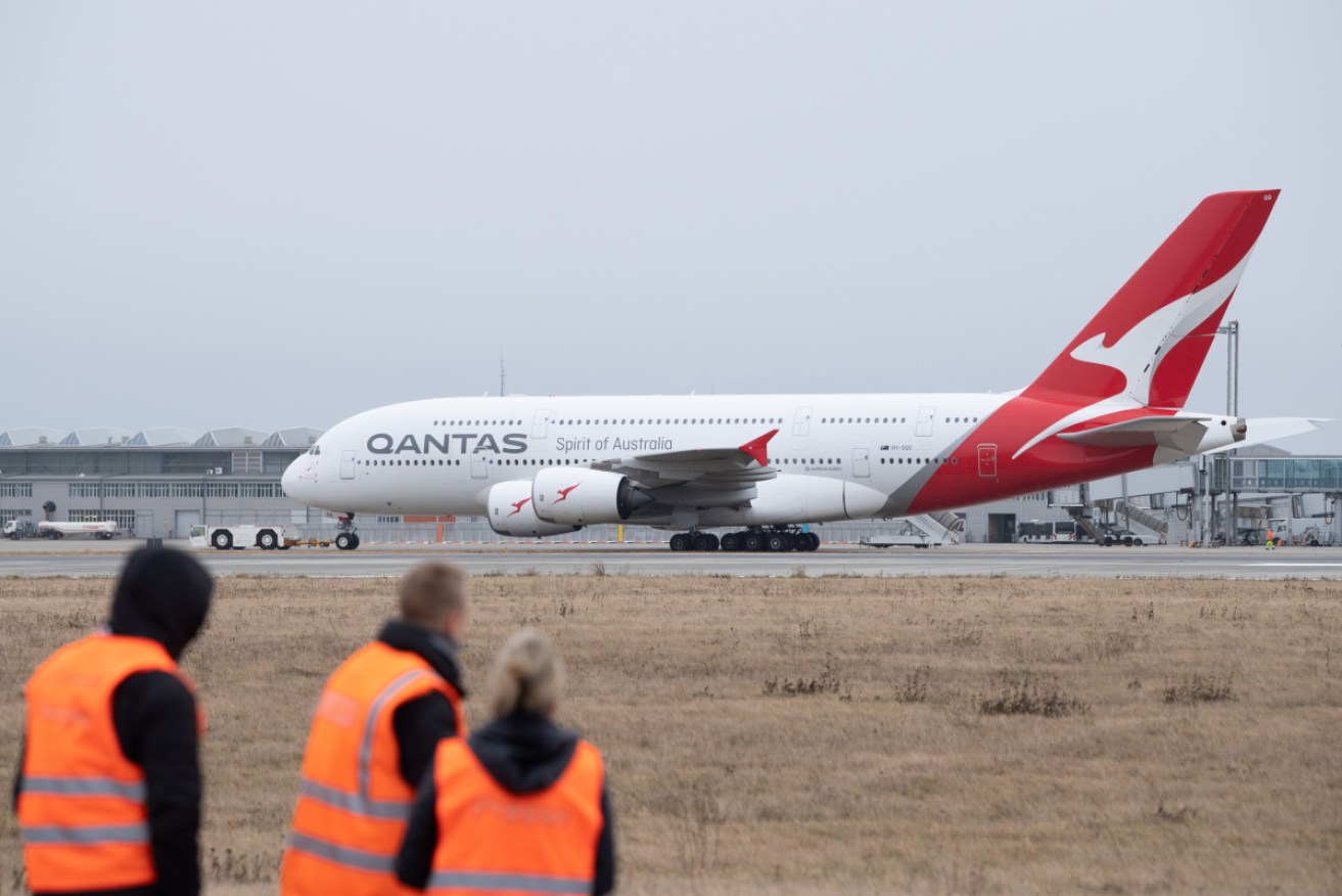 Passengers went through health checks before boarding the Qantas flight from Wuhan to Darwin.