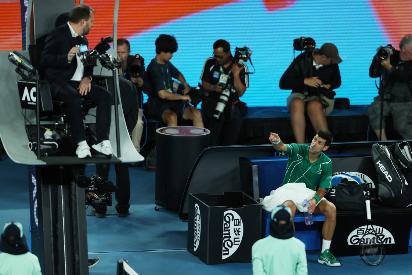 Novak Djokovic remonstrates with the chair umpire Damien Dumusois.