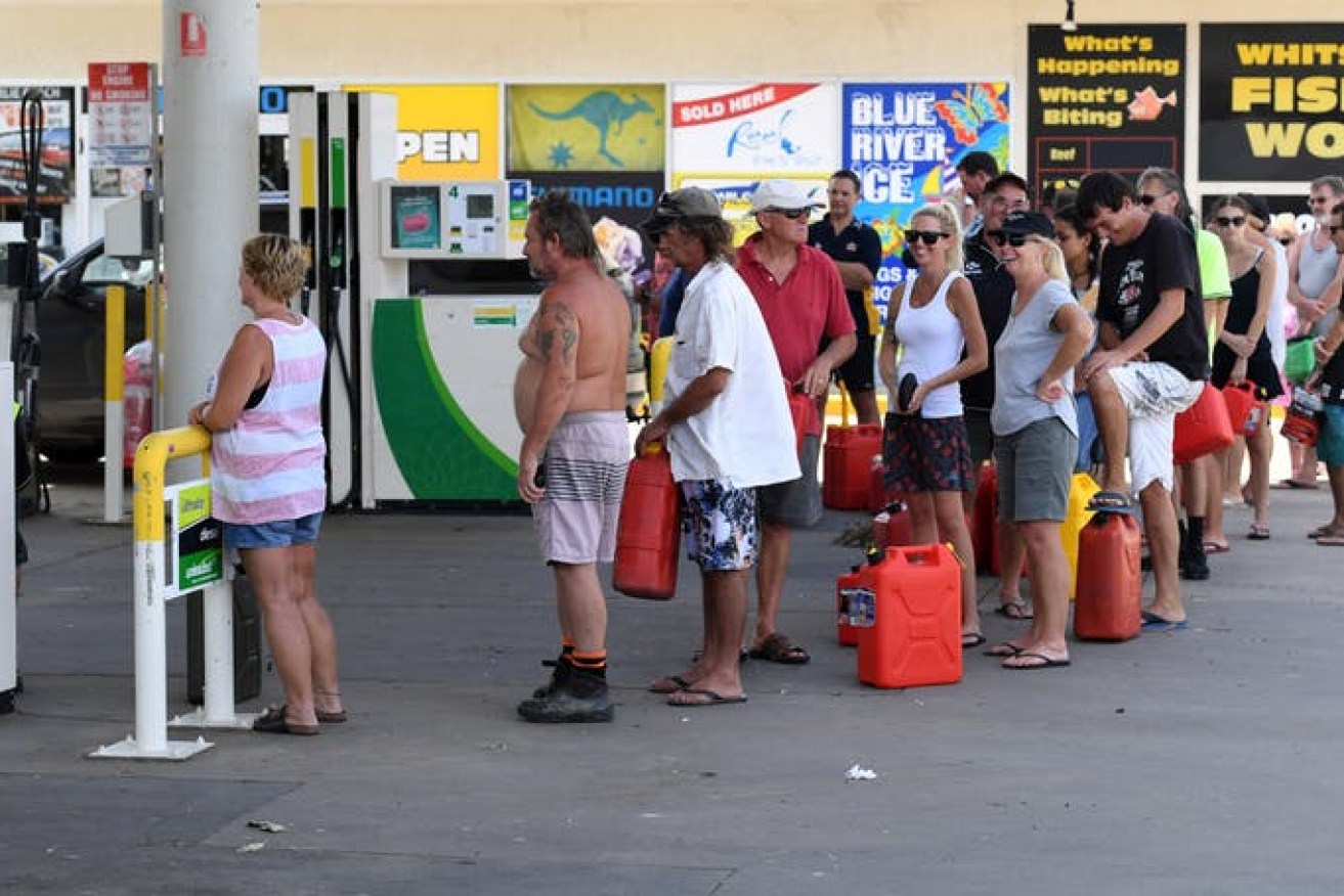People queue for petrol at Airlie Beach in March 2017 after Cyclone Debbie. 