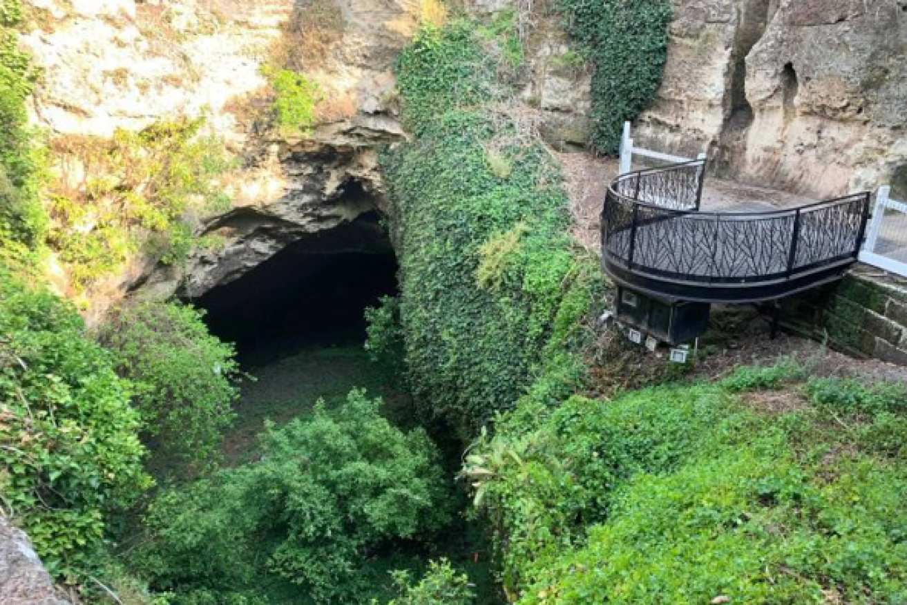 A natural wonder, the scenic sinkhole tempts observers to jump the safety fence for a closer look.