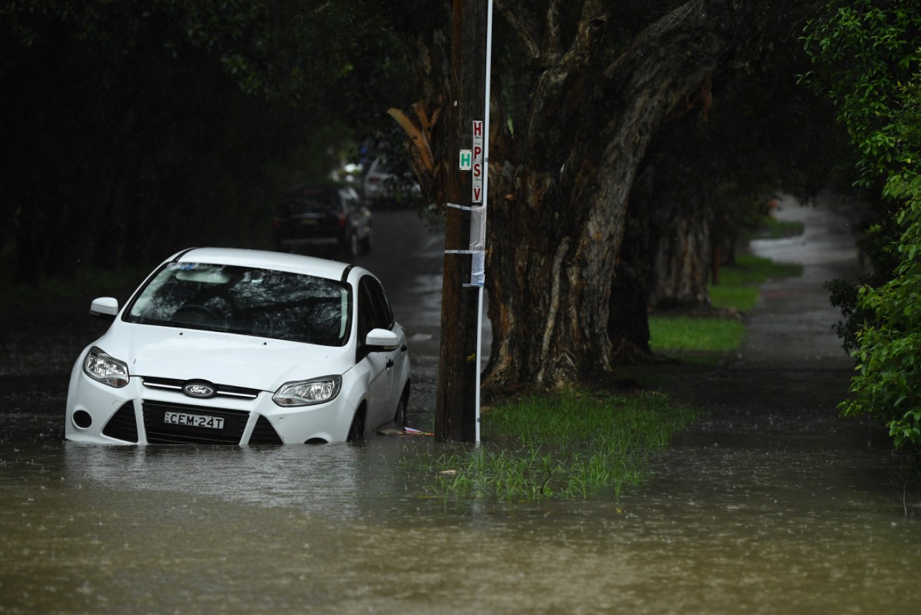 The deluge trapped cars in floodwaters at Marrickville in Sydney on Sunday. 