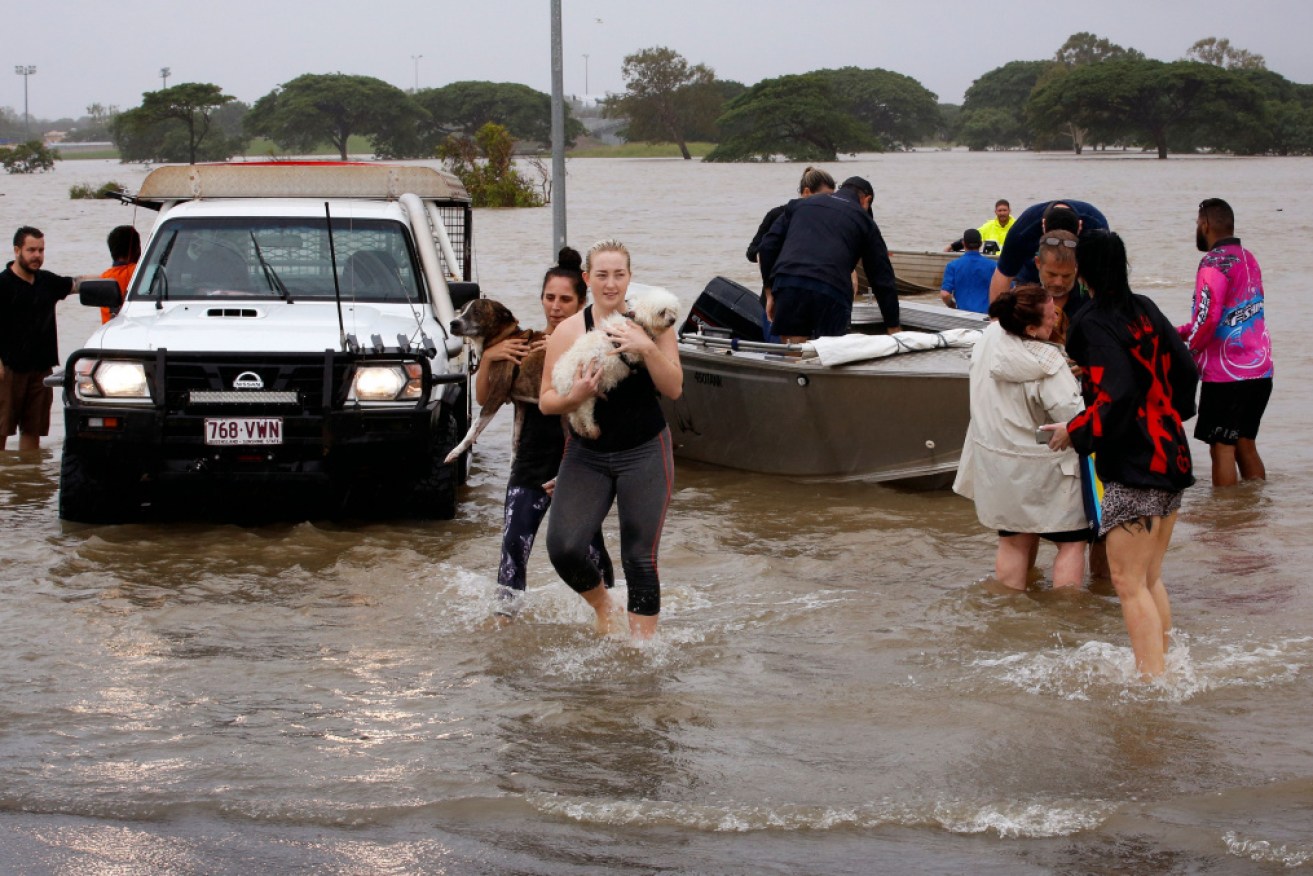 Flood-affected people are evacuated from Townsville over the weekend.