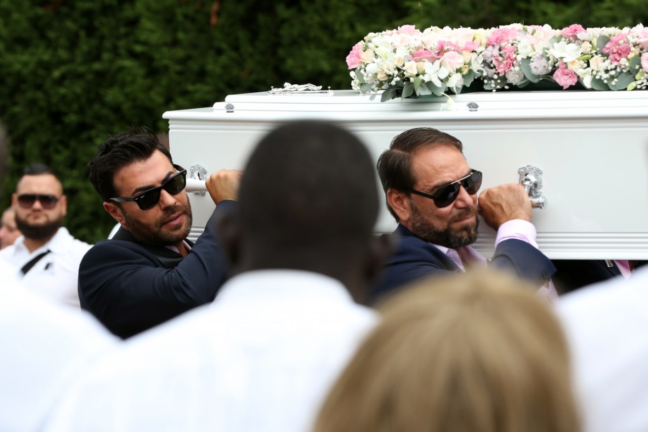 The coffins of Antony, 13, Angelina, 12 and eight-year-old Sienna Abdallah are carried at their funeral service. 
