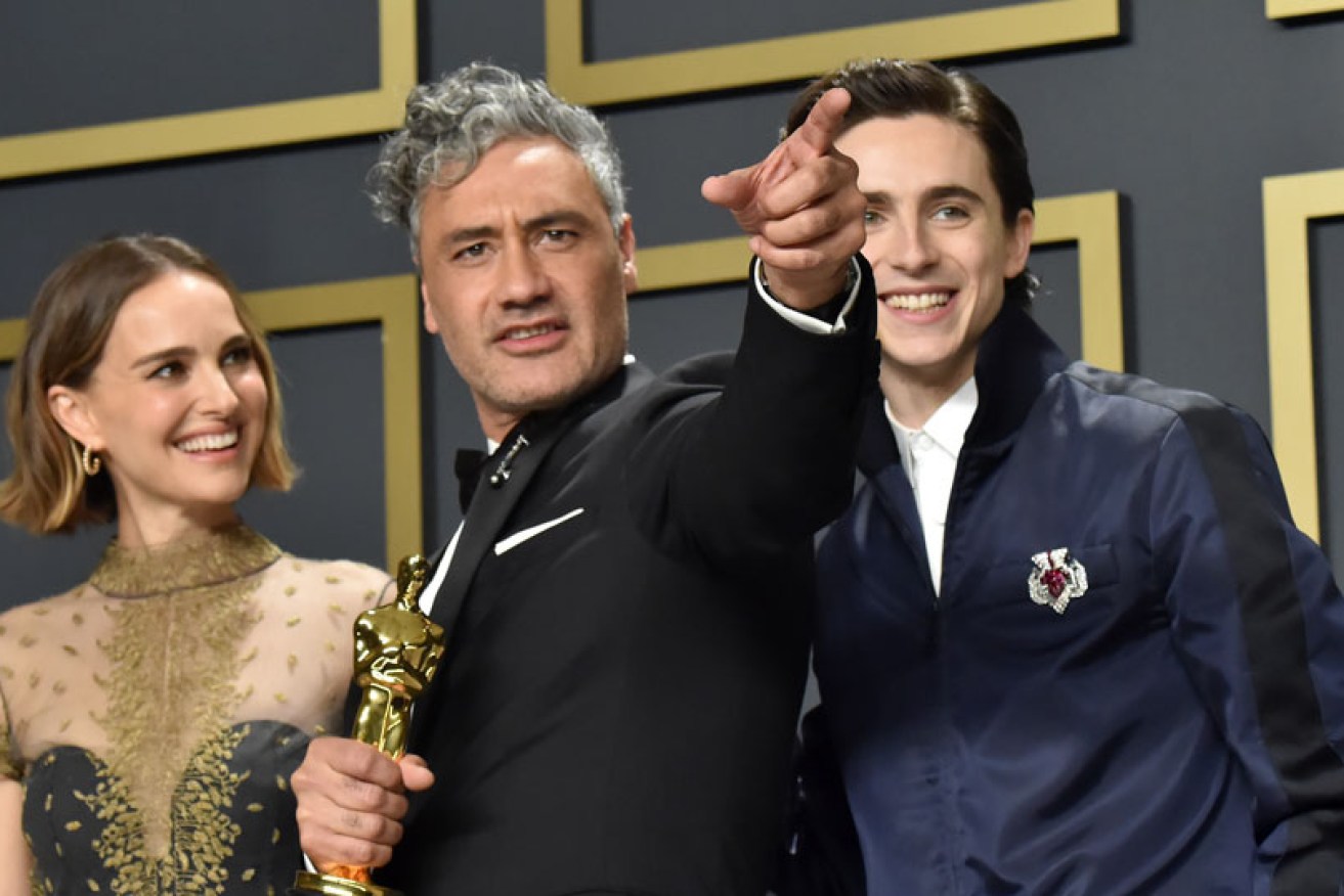 Natalie Portman (sans controversial cape) at Feb. 10's Oscars with Taika Waititi and Timothee Chalamet.