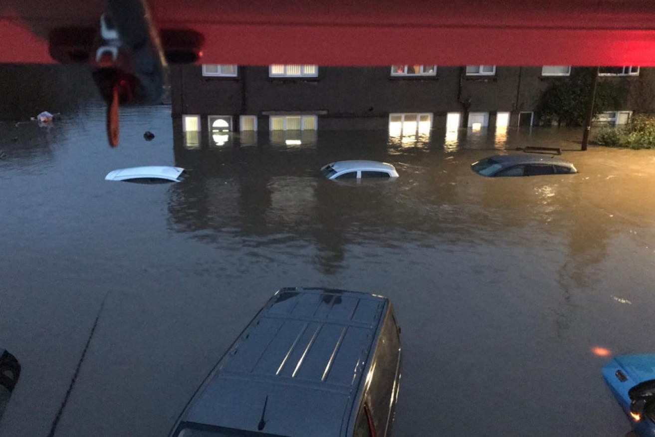 Cars semi-submerged by floodwater on Oxford Street, Nantgarw after Storm Dennis hits the UK.