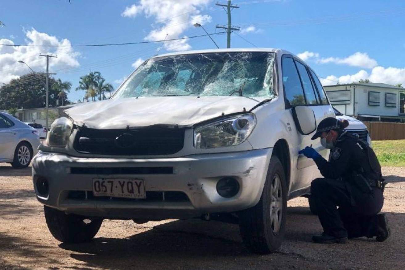 Police examine the blood-spattered car thought to be involved in Wednesday's hit and run.