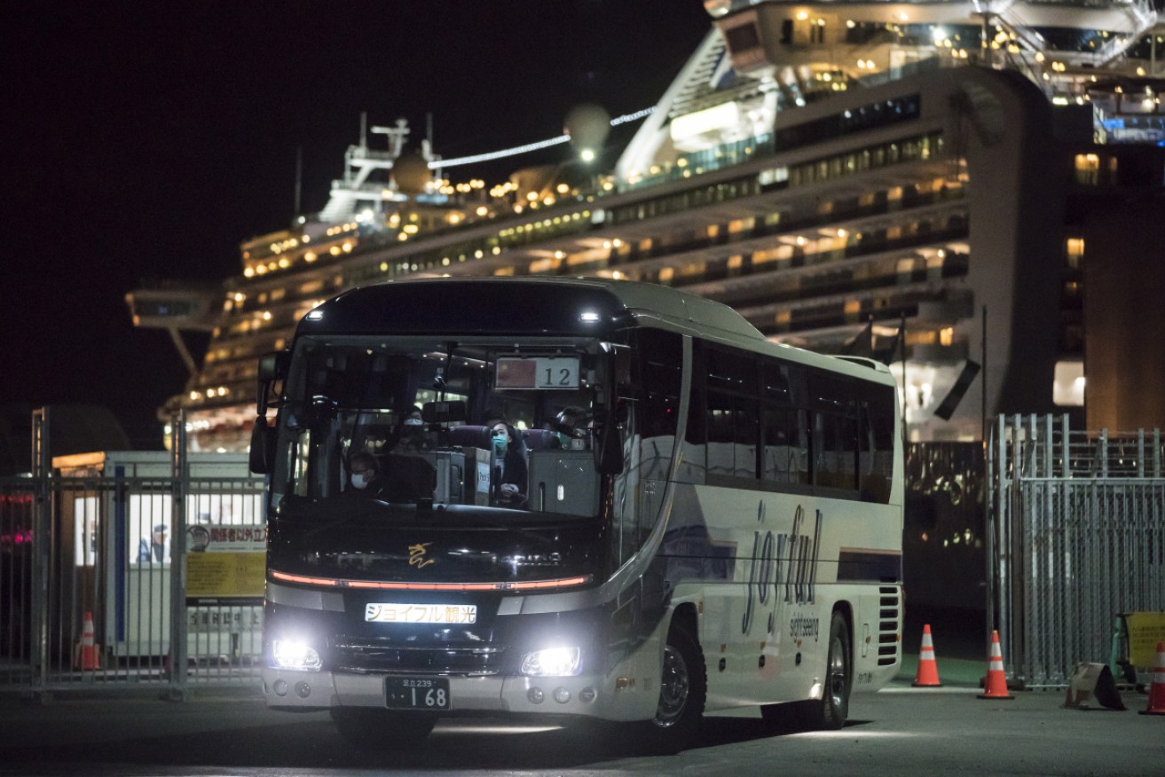 A bus carrying Hong Kong-bound passengers leaves  the cruise ship, hours before Australians take a similar exit. 