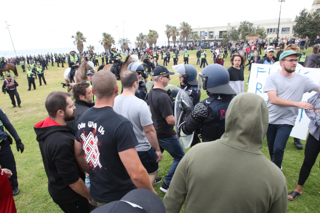 Protesters from the far-left and far-right clash with police on a Melbourne beach in 2019.