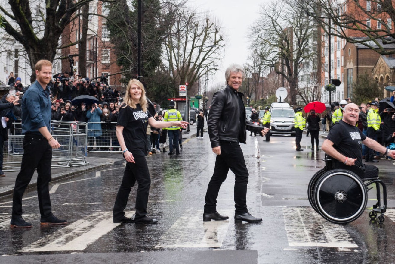 Harry and Jon Bon Jovi and members of the Invictus Games Choir at Abbey Road zebra crossing in London on Thursday.