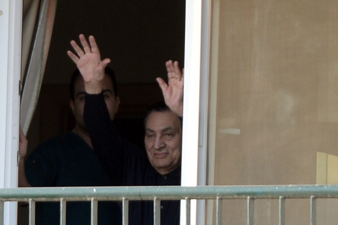 Egypt's former president Hosni Mubarak waves from his hospital room in Cairo on May 4, 2015.