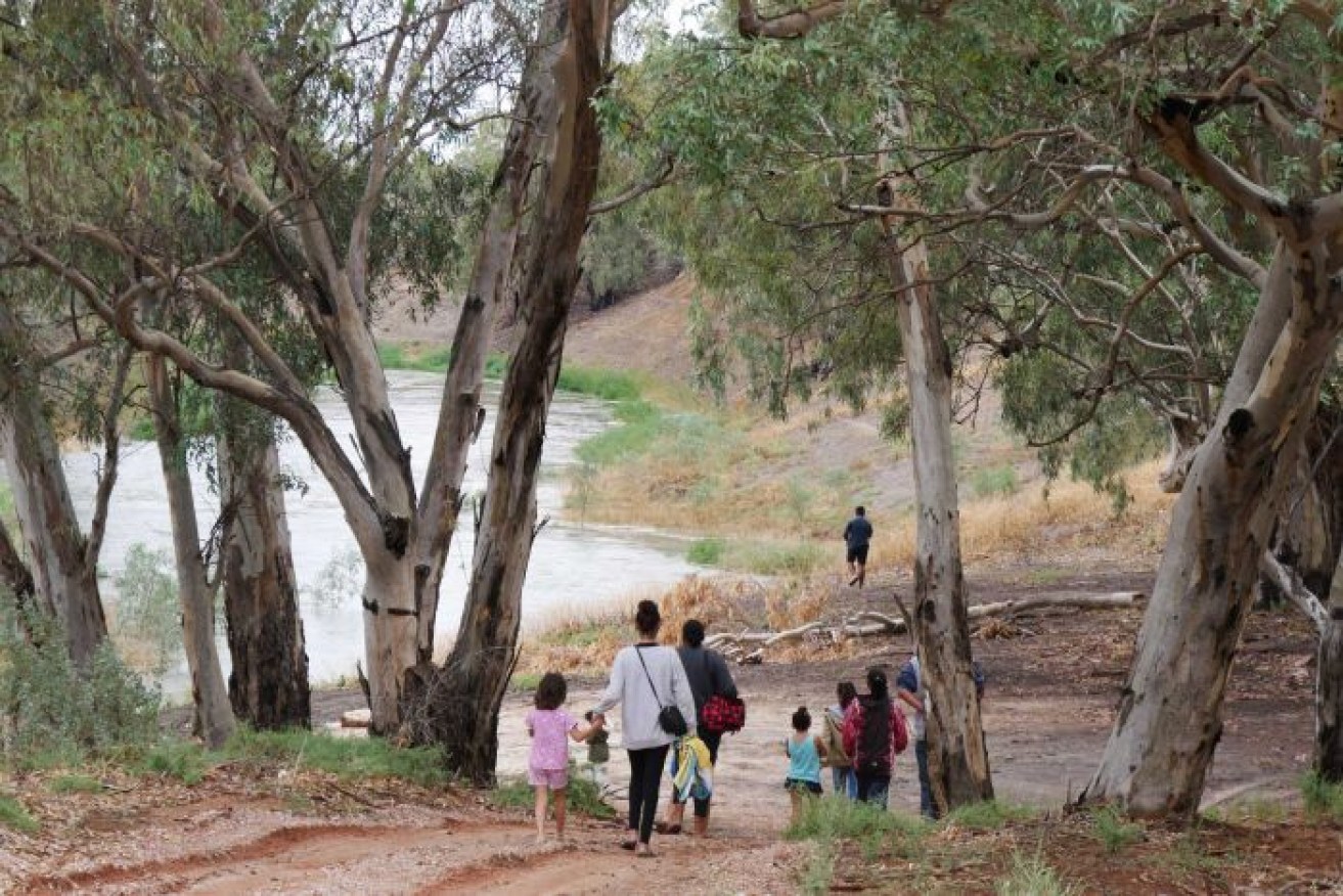 Families gather at the river after its welcome renewed flows.