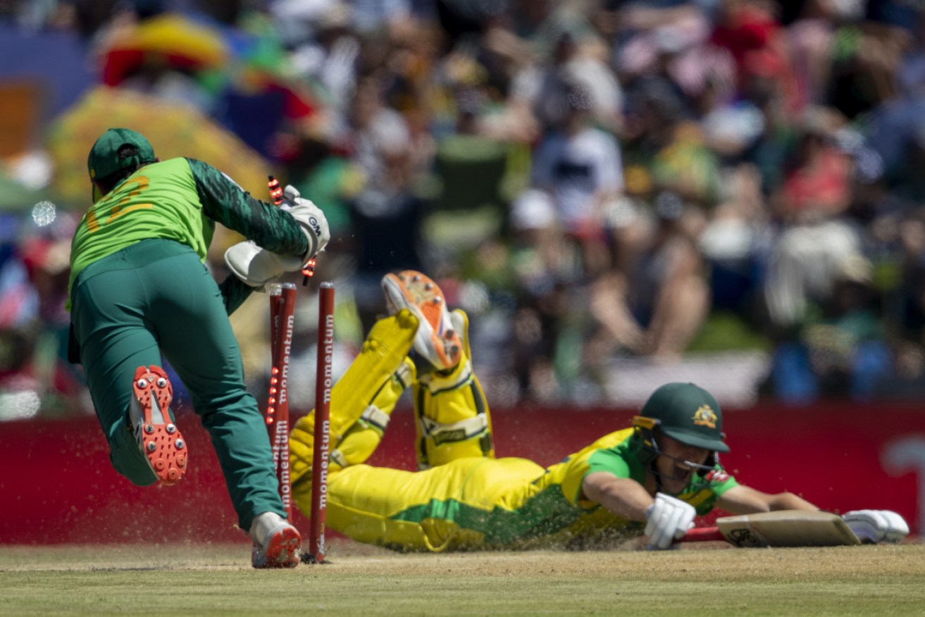 South Africa's captain Quinton de Kock, left, removes the bails to attempt a run out against Australia's batsman Marnus Labuschagne during the 3rd and final One Day International cricket match between South Africa and Australia. 