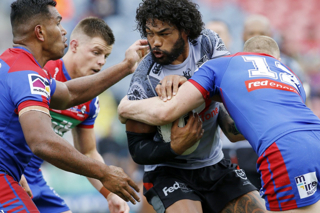 Under pressure: Adam Blair of the Warriors is tackled during the round one match against the Knights.