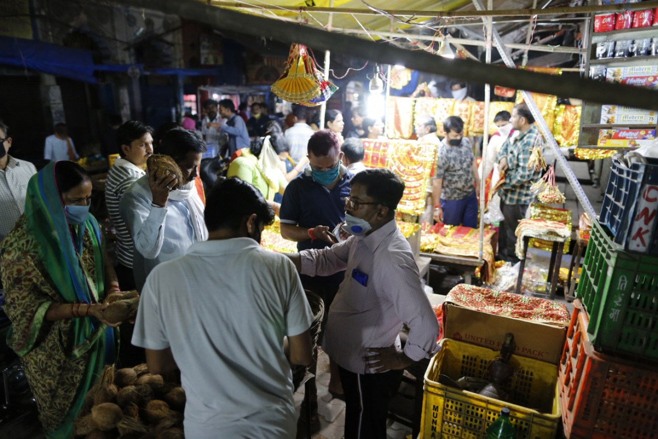 Hindus shop for religious items before India's coronavirus lockdown comes into effect.