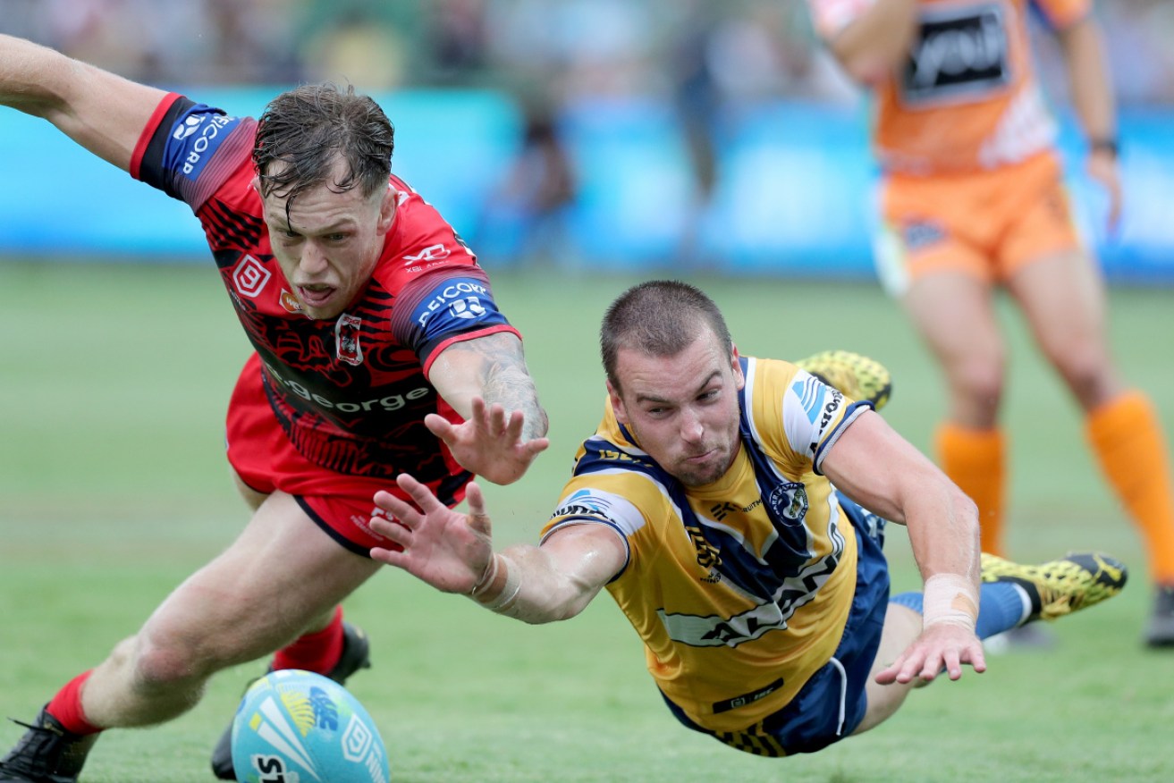 St George's Jackson Ford and Parramatta's Clint Gutherson dive for the ball at the NRL Nines in Perth.