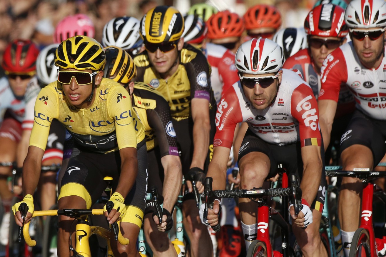 Egan Bernal in the leader's yellow jersey ushers the peloton along the Champs Elysees in the 2019 Tour de France.
