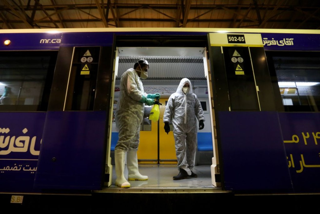 Tehran Municipality workers clean a metro train to avoid the spread of the COVID-19 illness in Iran.