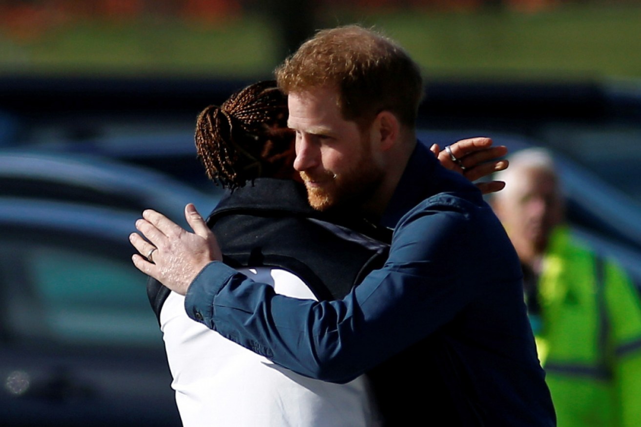 Prince Harry hugs Lewis Hamilton on March 6. Hamilton has been exposed to two people with COVID-19.