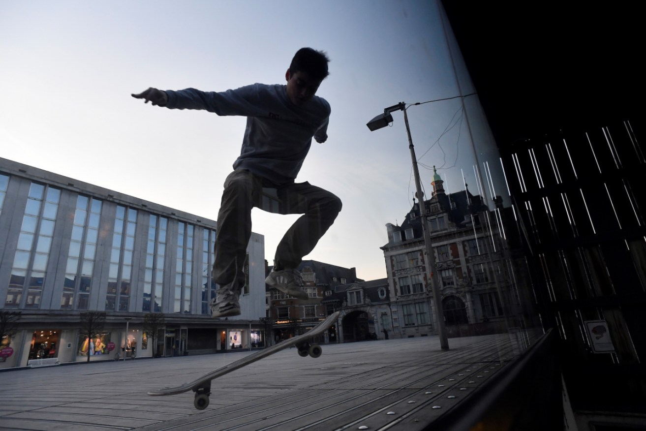 A teenager jumps with his skateboard in the Belgian city of Namur as a strict lockdown came into effect.
