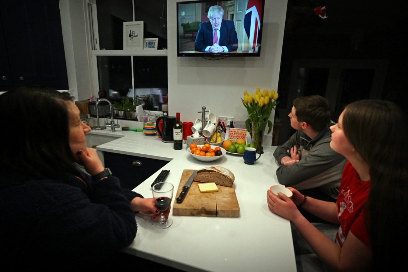 A British family watch as PM Boris Johnson orders the nation into lockdown.