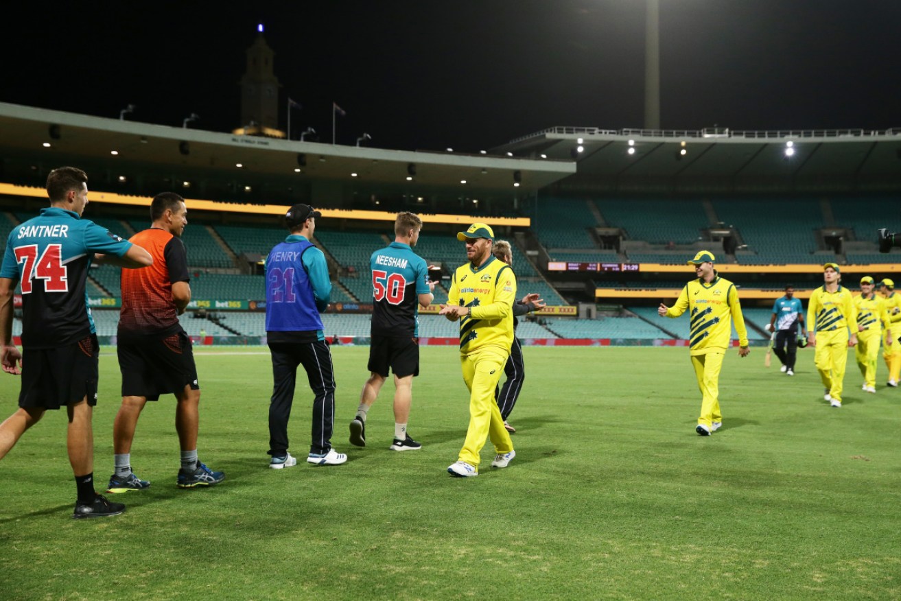 No handshakes: New Zealand and Australian cricketers greet each other after their match at the MCG. 