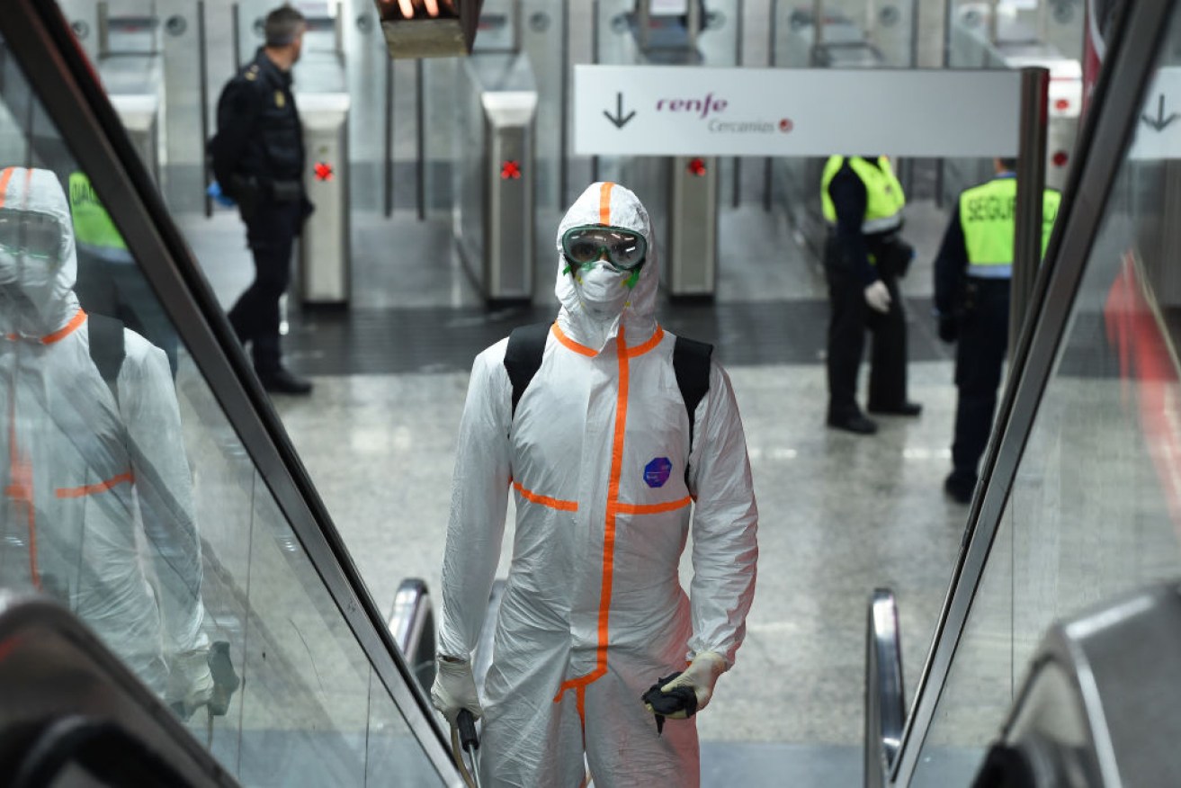 A member of the Spanish armed forces disinfects Puerta del Sol metro and train station.