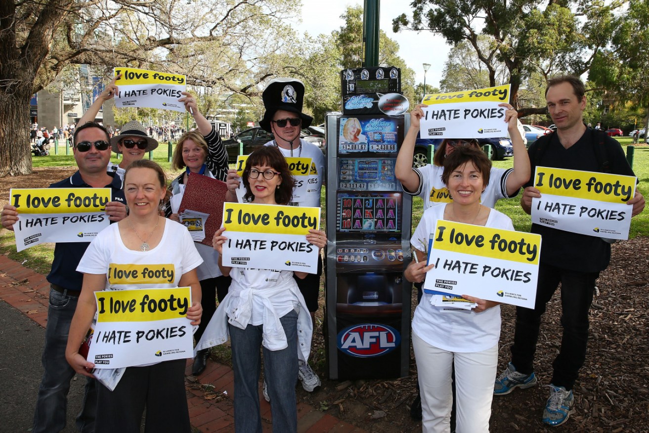 Anti-pokies protesters outside an AFL football match. 