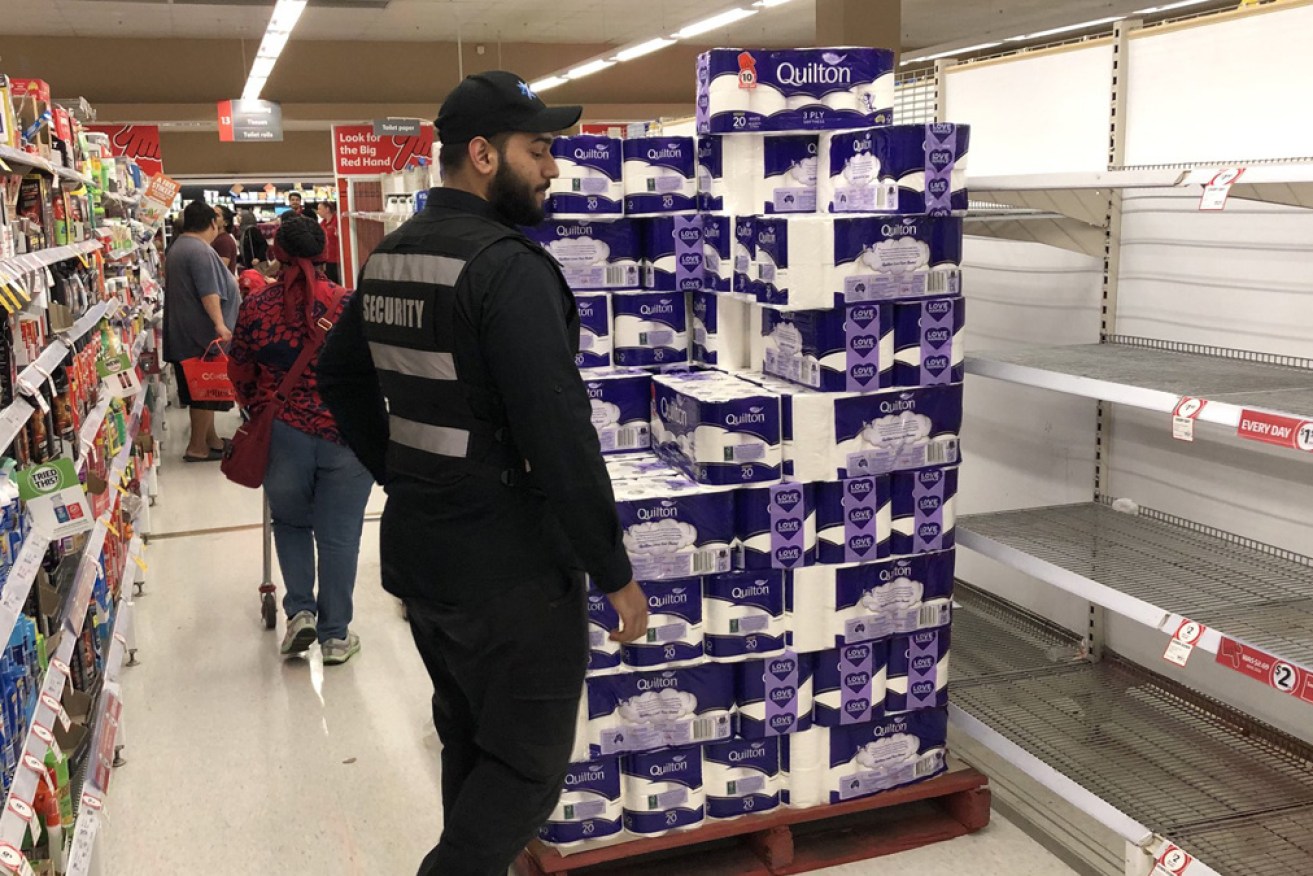 A security guard in the toilet paper aisle at Coles last week. Photo: Twitter