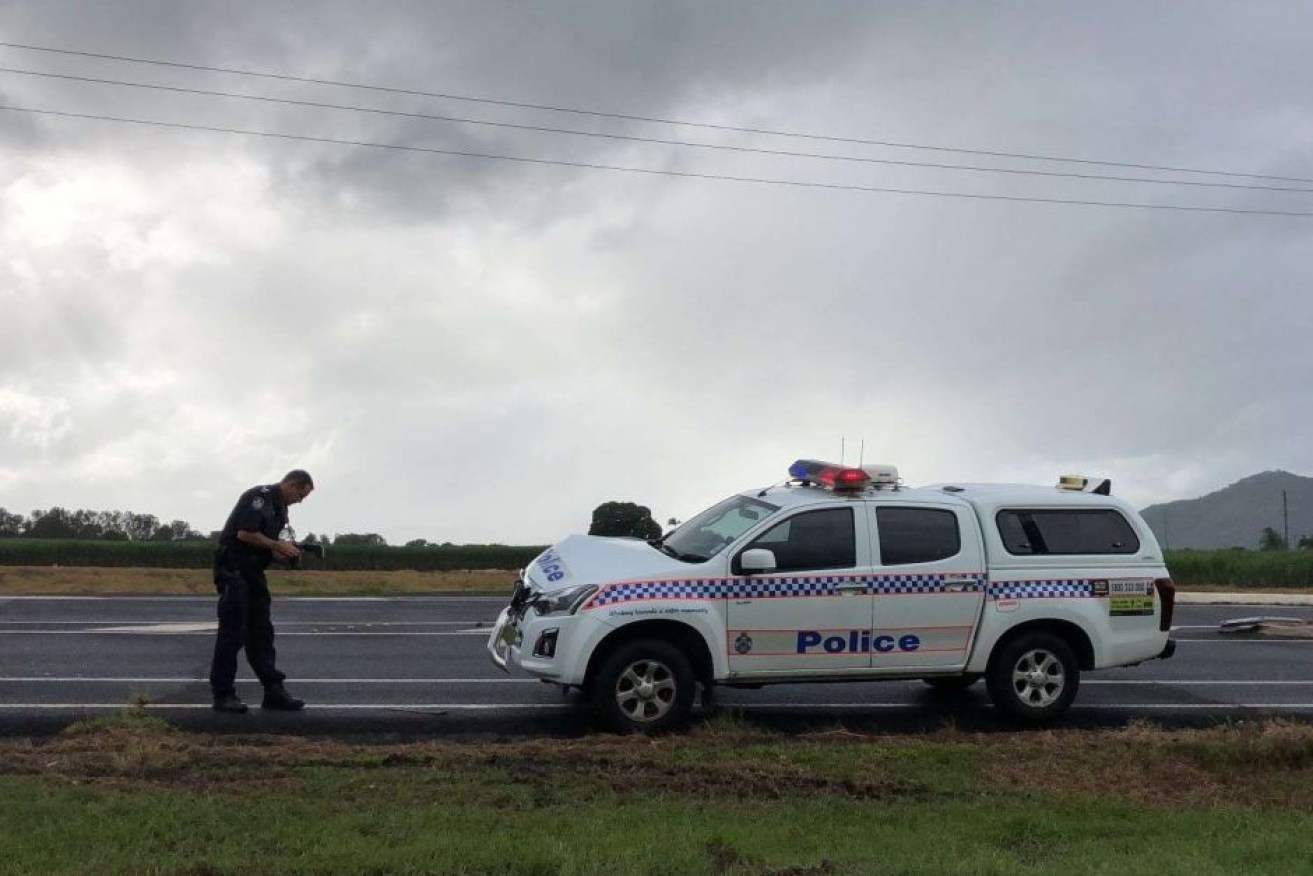 Qld Police said an officer was injured in the incident, near Cairns, on Sunday.
