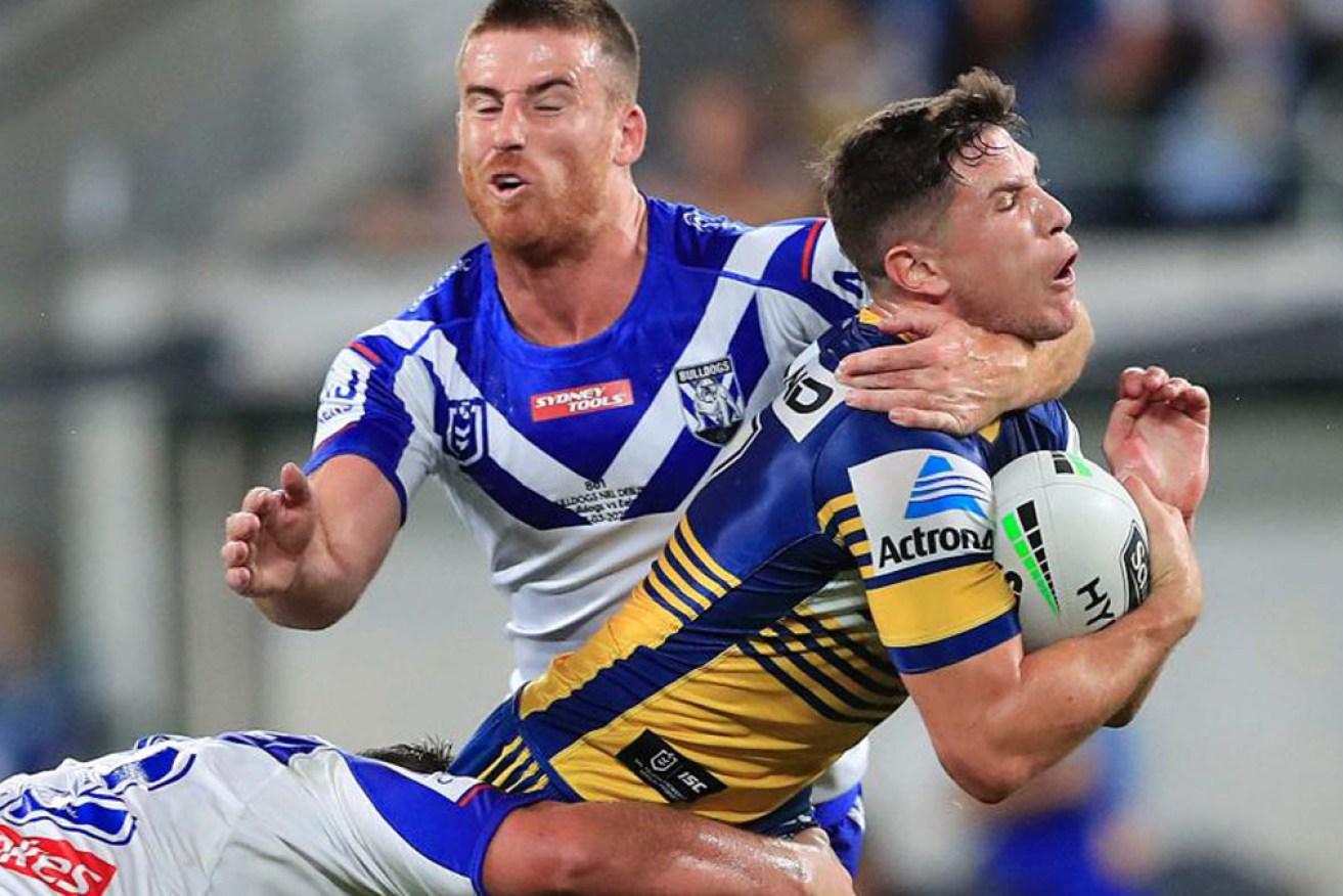 Parramatta's Mitchell Moses feels the full force of Dean Britt's tackle on Thursday night.