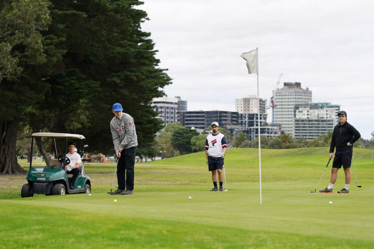 Golfers keep their distance at a Melbourne course in March before the lockdown. 